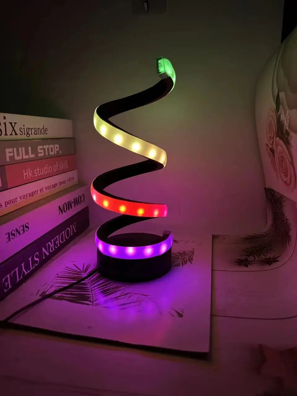 Modern dimmable spiral LED table lamp for desk and home lighting.